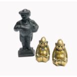 Two polished bronze Buddah type figures, height 6cm, together with cast iron figure of a man wearing