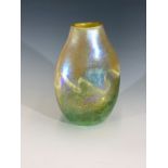 A Norman Stuart Clarke art glass vase, decorated with irredescent and green foam topped waves,