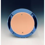 An Art Deco period circular copper toned wall mirror with colbalt blue border. Diameter 37.5cm.