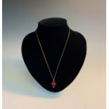 A very high purity gold cross set six rubies Ht 19mm with a gold chainCondition report: Electronic