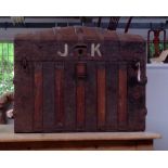 A domed top seaman's trunk, with nautical sailing ship stencilled to each end and initialled J.K,