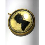 A verre eglomise silhouette portrait of a lady, in gilt metal pendant mount.