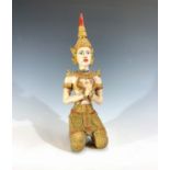 A painted brass figure of a kneeling Balinese dancer, height 25.5cm.