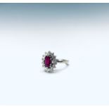 An 18ct white gold ruby and diamond oval cluster ring