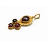 An ancient Roman gold pendant set with four garnets, maximum height 37mm 5.3gm Provenance: Found