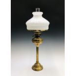 A brass reeded column oil lamp with circular base. Overall height 76cm.