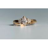 An 18ct gold ring set a navette cut diamond of aproximately 0.25ct flanked by diamond set