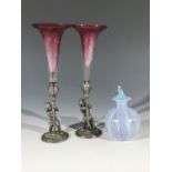 A pair of Victorian cranberry glass epergnes with figural metal stands, lozenge registration mark to