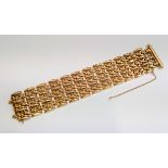 A 1950's 18ct gold braceletwith stands of flowers and ribbed links and patent sprung squeeze clasp