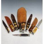 A collection of nine sheath knives, mainly English with horn grips, two in a double sheath, the