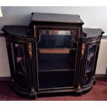 A Victorian ebonised credenza, with ormolu mounts and ivory inlay, the central glazed door opening