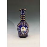 A Turkish Market glass decanter, the blue ground with three head and shoulder portraits of Naser
