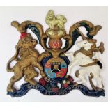 A late 19th/early 20th century cast iron and polychrome painted wall mounted royal coat of arms.