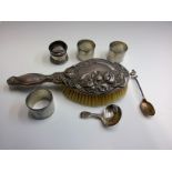 A Victorian silver caddy spoon, an ornate Art Nouveau silver mounted brush, three Cornish tin napkin
