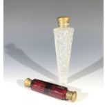 An early 20th century hobnail cut glass perfume flask of tapering form, length 16.5cm, together with