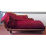 A Victorian mahogany chaise longue, the padded back, arm and seat on turned tapering legs, height