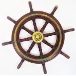 A wooden ship's wheel, diameter 75cm, together with a brass plaque and a collection of paper