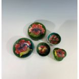 Two Moorcroft 'Hibiscus' pattern pin trays, 11.5cm diameter, a trefoil shape trinket dish in the