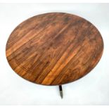 An elegant rosewood and mahogany tilt top breakfast table, 19th century, the circular rosewood top
