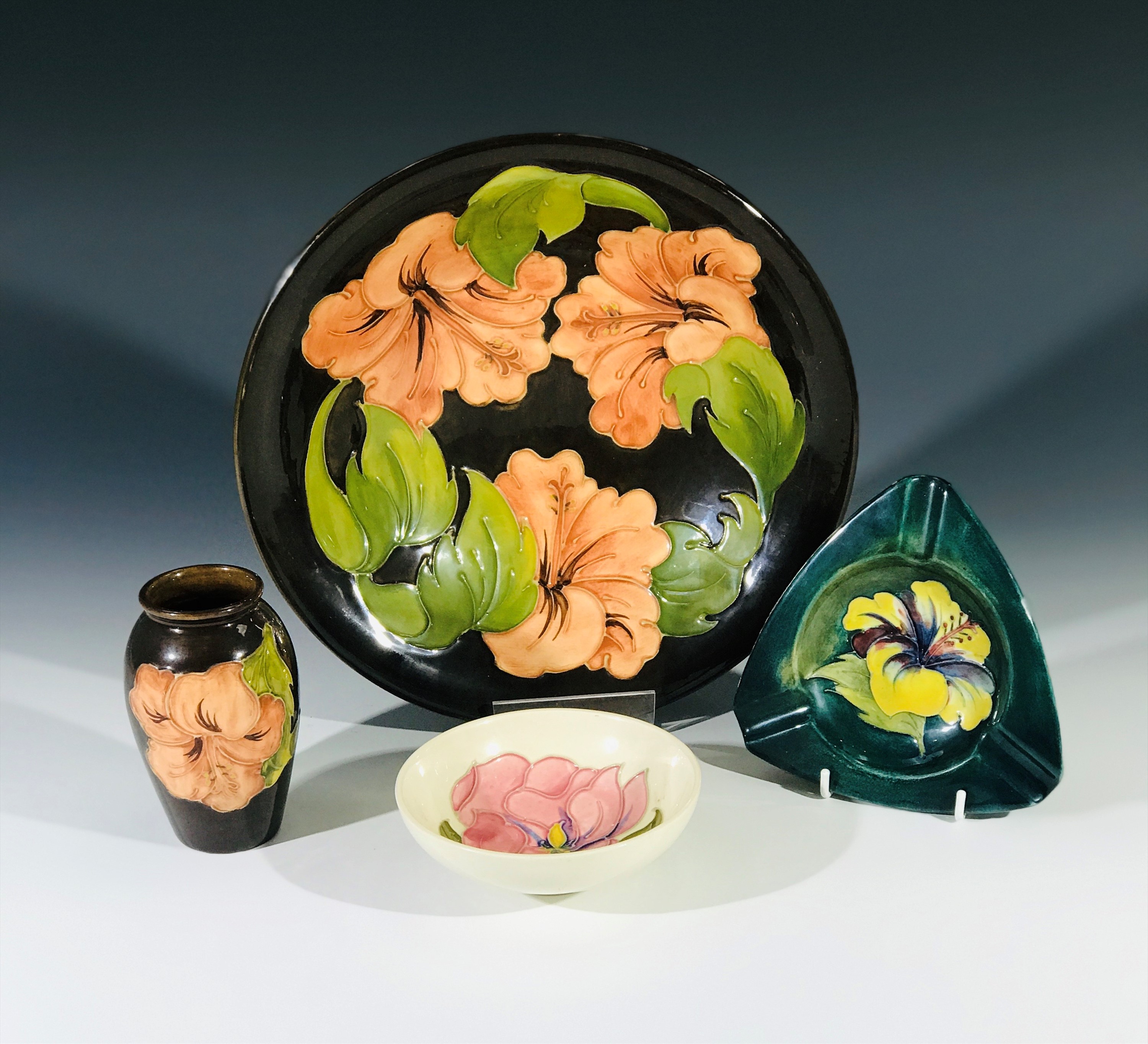 A Moorcroft 'Hibiscus' pattern bowl, 25cm diameter, and matching vase, together with an 'Hibiscus'