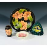 A Moorcroft 'Hibiscus' pattern bowl, 25cm diameter, and matching vase, together with an 'Hibiscus'