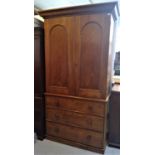 A Victorian linen press, with a pair of panelled doors enclosing trays, the lower part with three