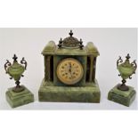 A Victorian onyx clock garniture, the circular dial with ornate gilt mask and Arabic numerals, the