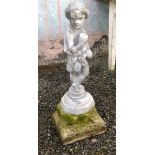 A lead garden statue of a boy holding grapes, on stone base. Height 85cm.