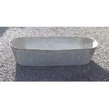 A long galvanised tin bath, length 130cm, together with another, length 72cm.