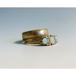 A 9ct gold Victorian style ring set with opals and a 9ct bandCondition report: Size of opal ring P