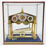 A Congreave type rolling ball clock, height 33cm, width 29cm, in glass case.Condition report: