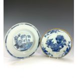 An 18th century Delft blue and white plate, painted with a tree in a fenced garden, diameter 23cm,