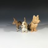 A Sylvac model of a seated dog, height 13cm, together with a Szeiler basset hound and a Beswick