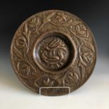 An Arts and Crafts period John Pearson design Cornish art copper charger of circular form, the