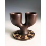 A brown glaze Troika pottery double egg cup, St Ives rubber stamp mark, height 9cm.Condition report: