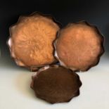 A set of three graduated Cornish art copper trays, attributed to the Eustace brothers of Hayle