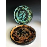 Two Celtic Pottery plates one decorated with a horses head and the other a lion, each 24cm