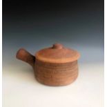 A Leach Pottery lidded casserole dish, width including handle 25cm, height 13cm, impressed studio