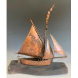 Mark PENROSE (20th/21st Century) A copper sculpture of a sailing boat, PH.107On driftwood base