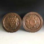 A Henry Eva copper charger of circular form, embossed with poppy seedheads, signed, together with