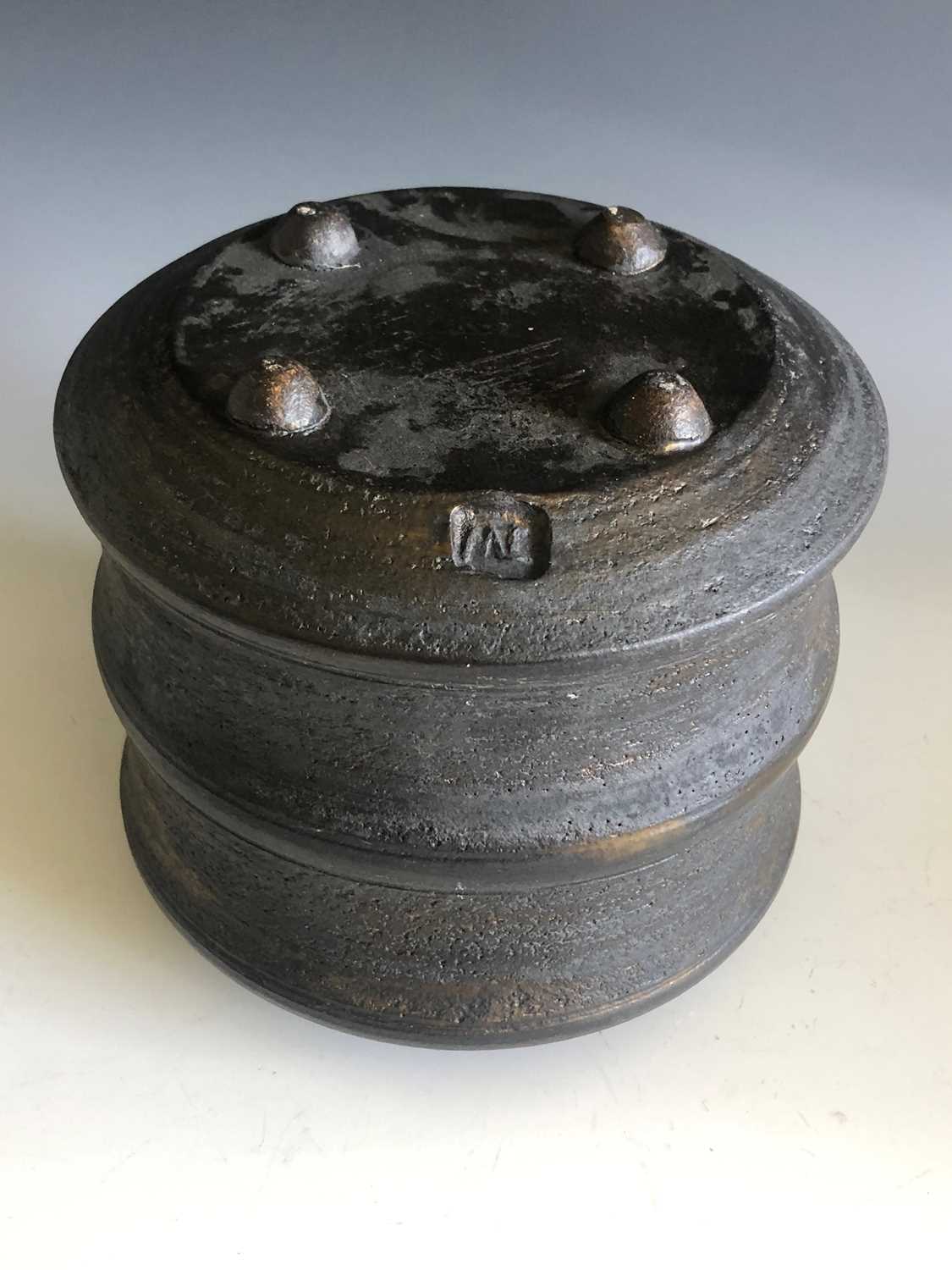 A Jason Wason black stoneware lidded pot with mottled gold glazed and on four domed feet, height - Image 2 of 2