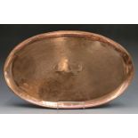 An Arts and Crafts period Herbert Dyer copper tray of oval form, decorated with a fish border and