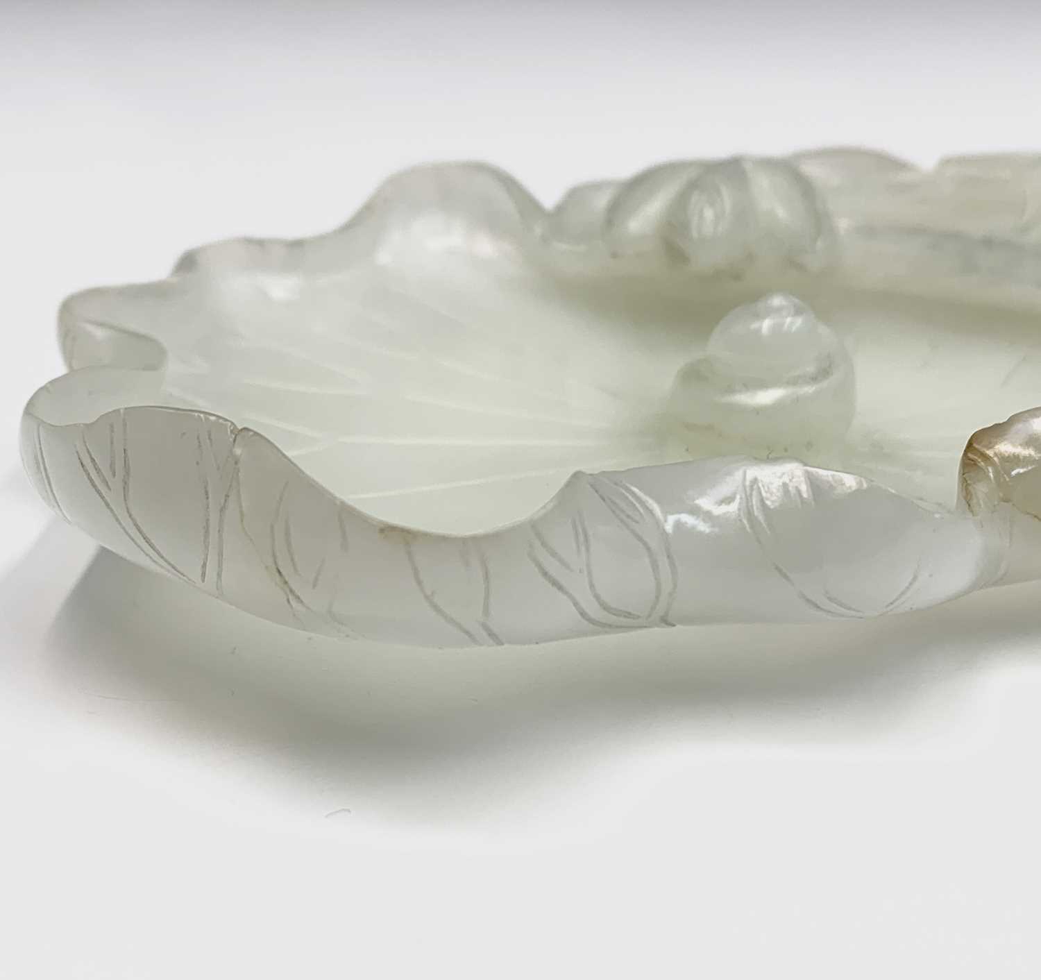 A Chinese white jade 'lotus leaf' brushwasher, 19th Century, height 2.5cm, width 13cm, depth 8.5cm. - Image 13 of 20