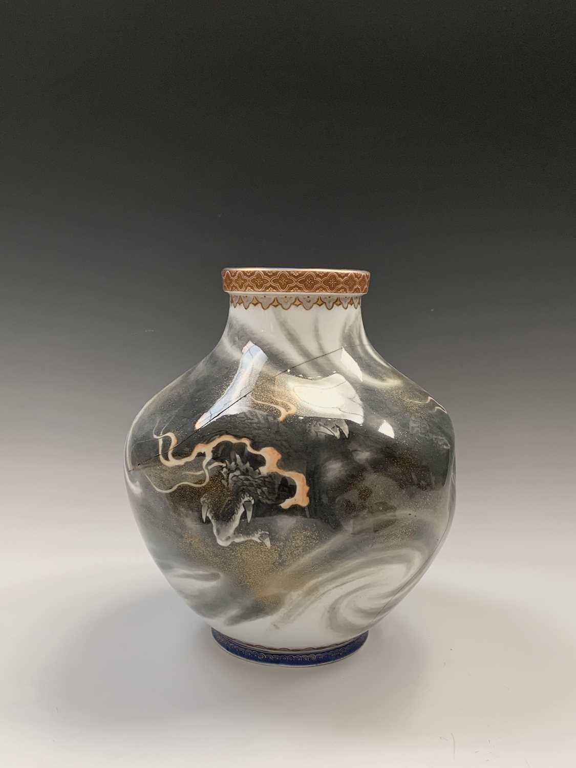 A Japanese porcelain vase, Meiji Period, the dimpled body decorated with stylised dragons, height