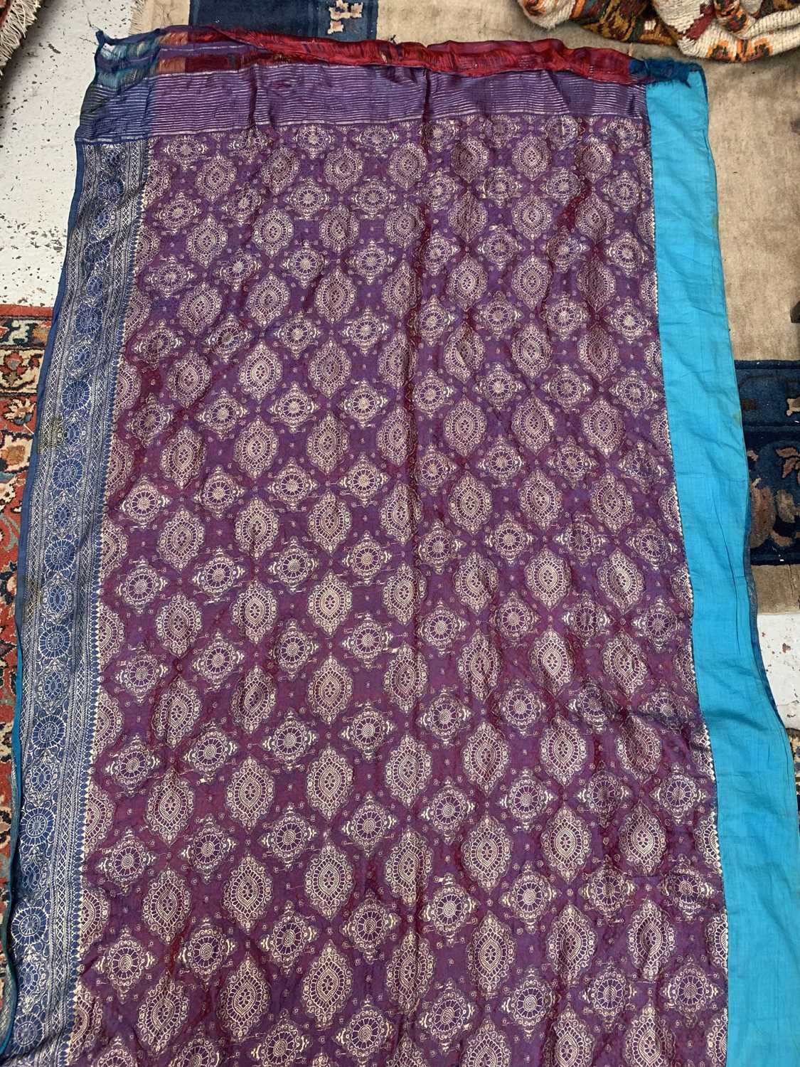 A North Indian sari, the red ground with rows of gold metal thread medallions, 488 x 109cm.Condition - Image 15 of 17