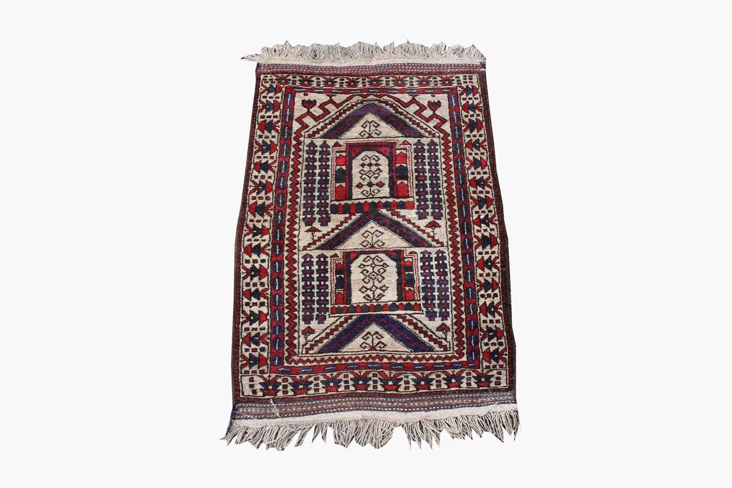 A Belouch prayer rug, the polychrome mihrab with hooked guls and motifs, within an ivory