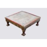 An Indian low table, the frieze with mounted brass flowerheads, on turned legs, height 21.5cm,