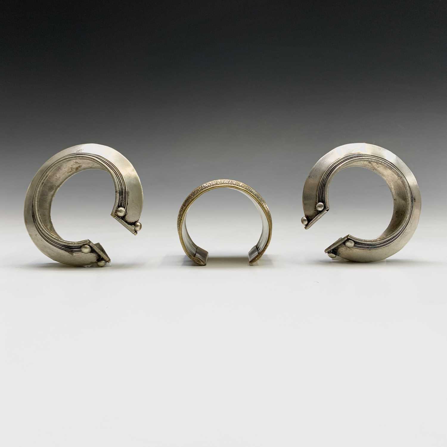 Two silver tribal bangles and a brass cuff, Laos.Condition report: the inner size of all three - Image 4 of 8