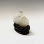 A fine Chinese white jade carving of a duck, Qing dynasty, on a wooden stand, height of jade 5cm,