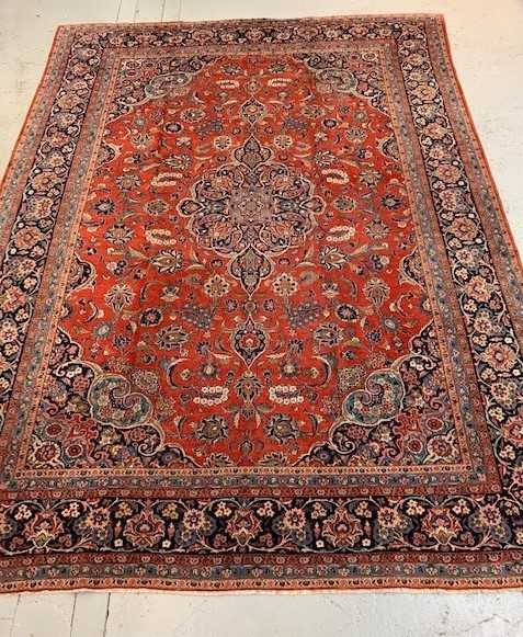 A Kashan Carpet, West Persia, the madder field with a central indigo lobed pole medallion, with